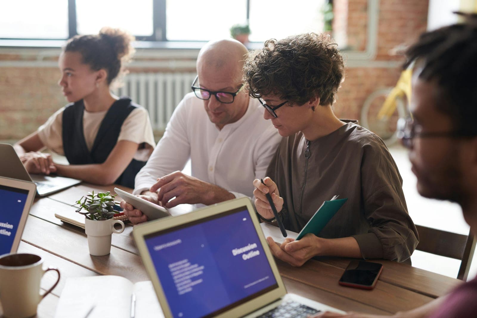 A multidisciplinary team collaborating around a shared table.